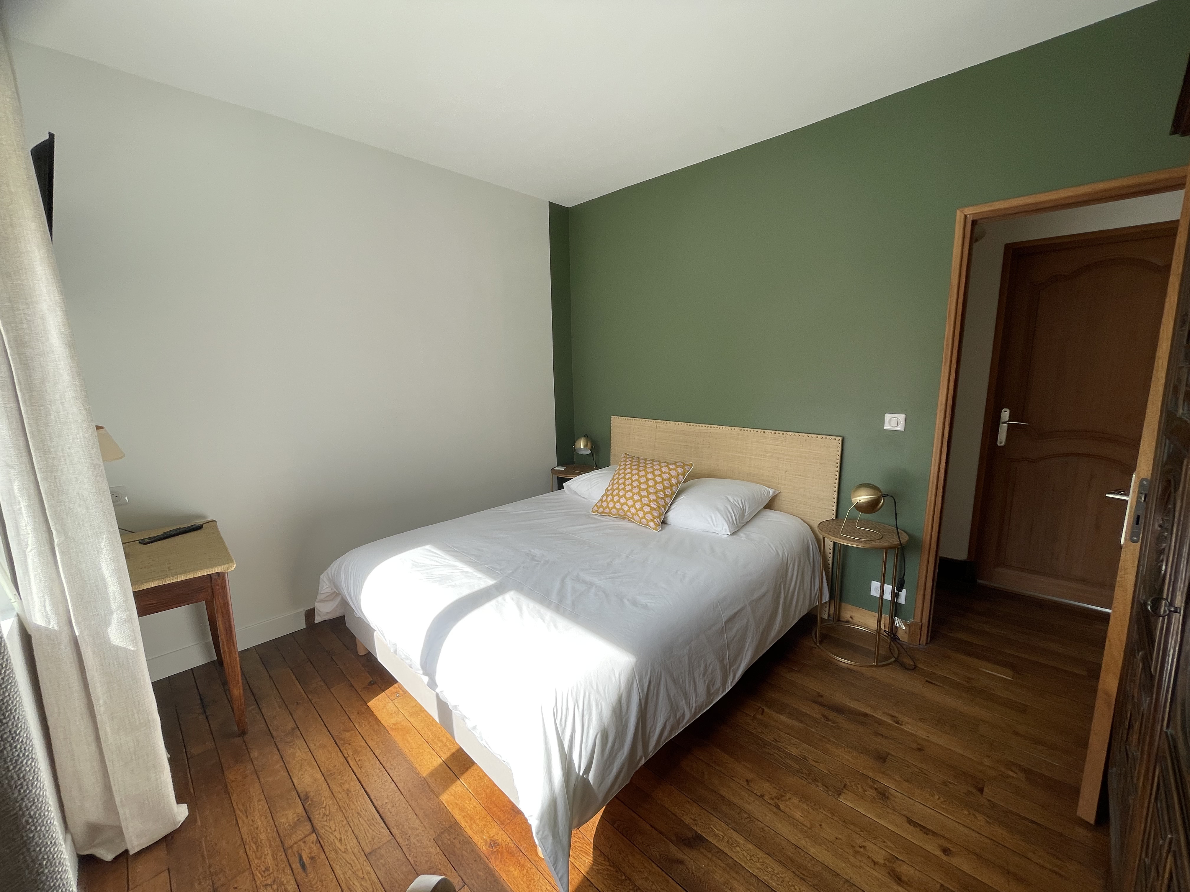 Photo of a man giving a talk on stage with blue curtains behind him.