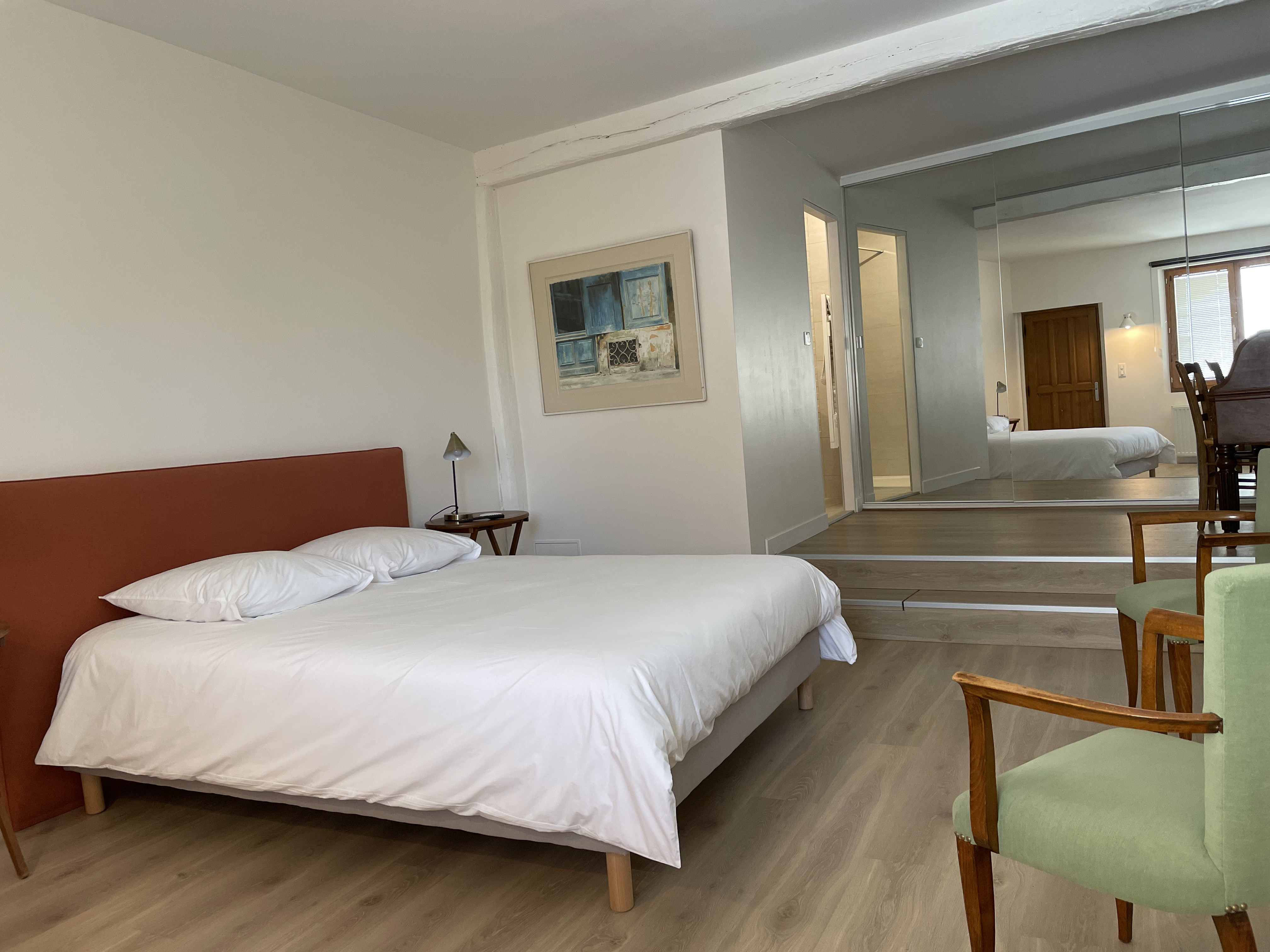 Photo of a man giving a talk on stage with blue curtains behind him.
